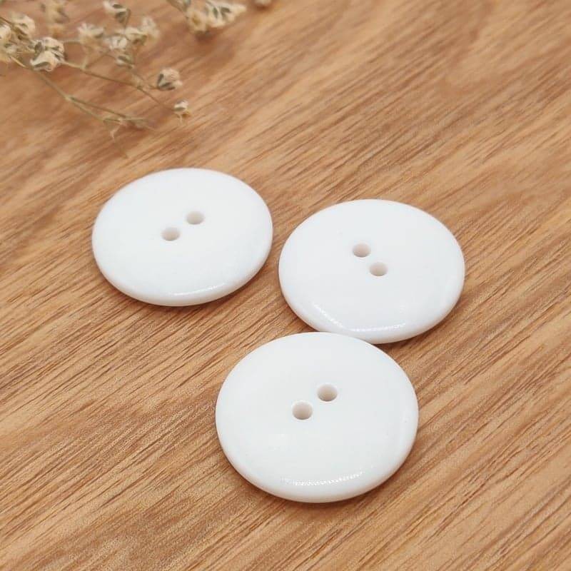 White glossy synthetic button